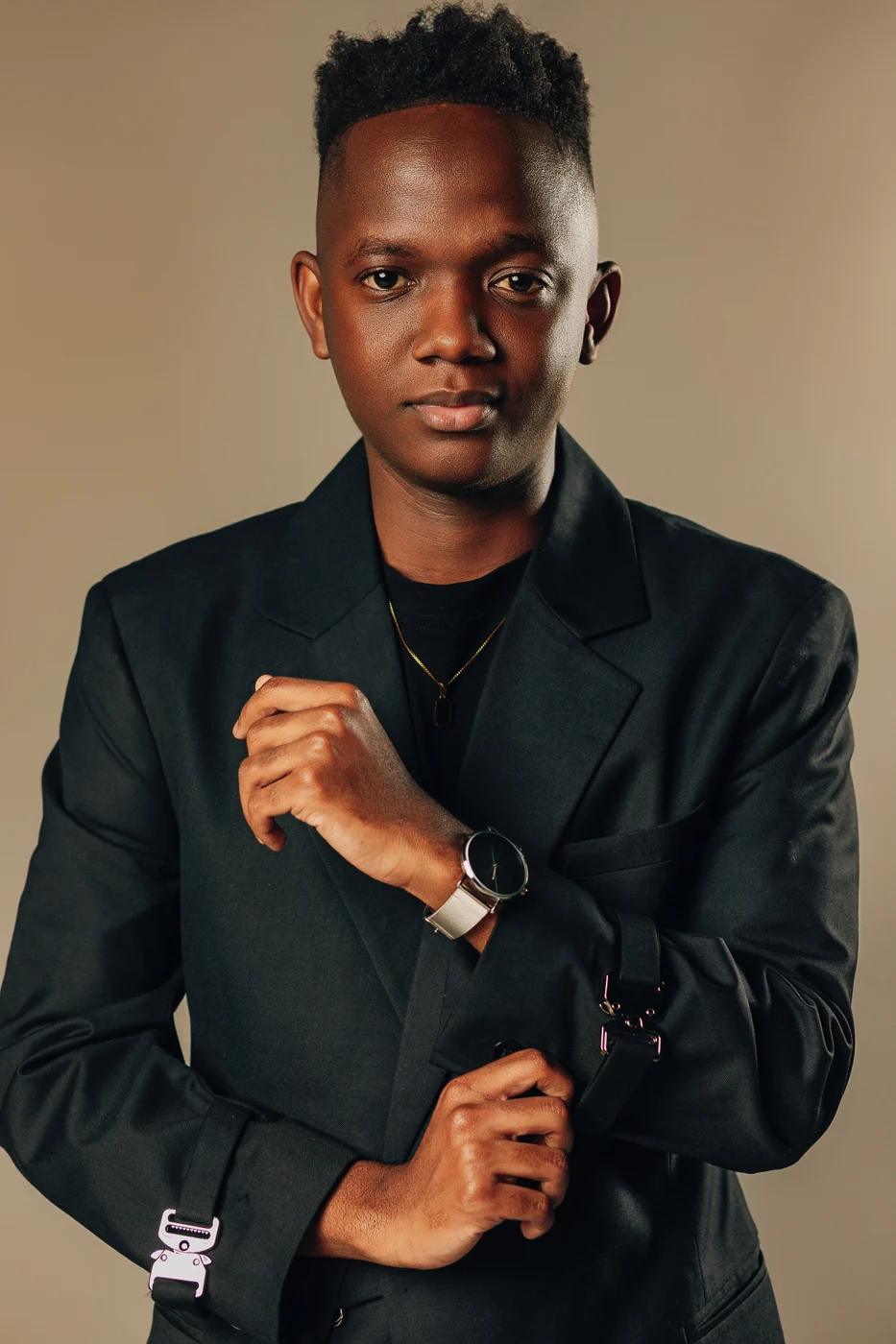 Viny in a black blazer, looking toward the camera